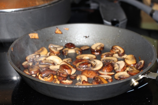 We sauteed onions for the tomato sauce, then used the same pan to saute mushrooms in a bit of olive oil.  
